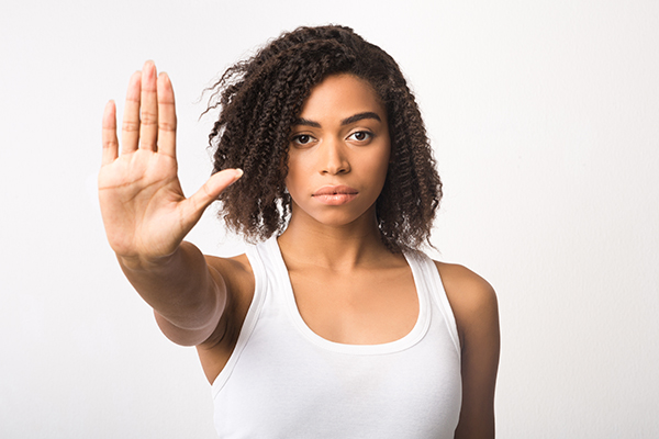 Black girl showing stop sign on white background